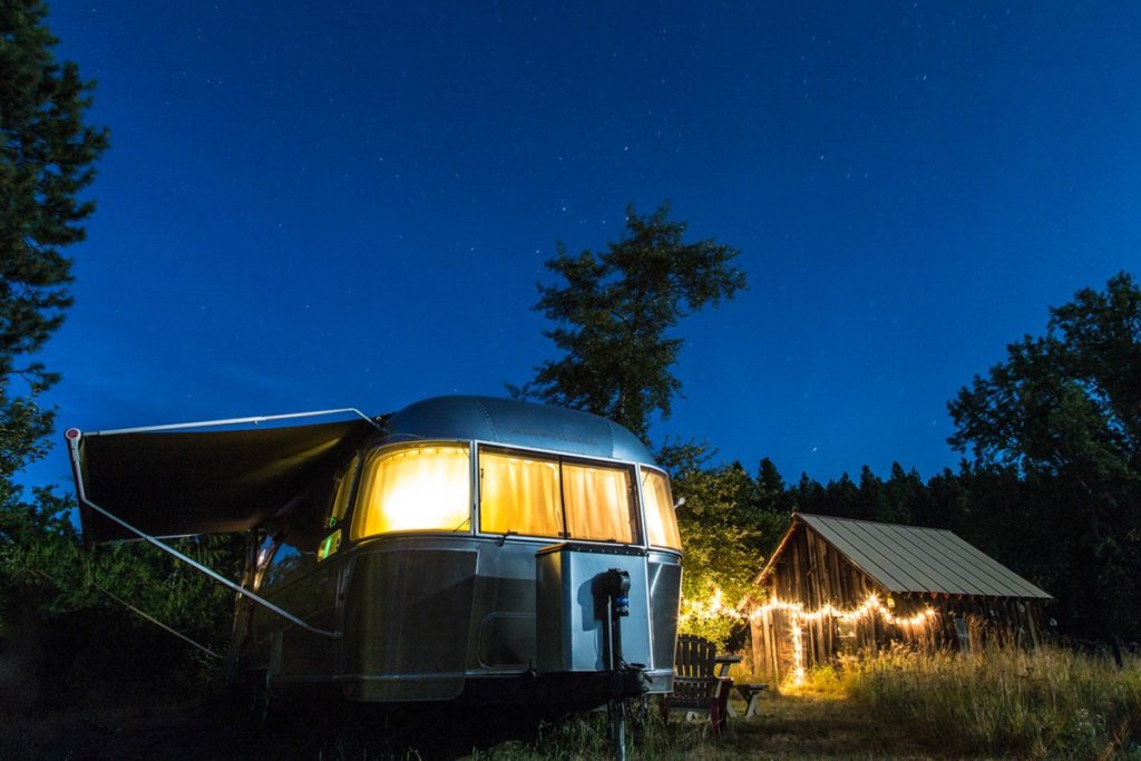 Airstream Travel Trailer with decorative lighting at twilight