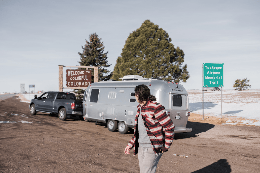 Airstream parked beside Colorado sign