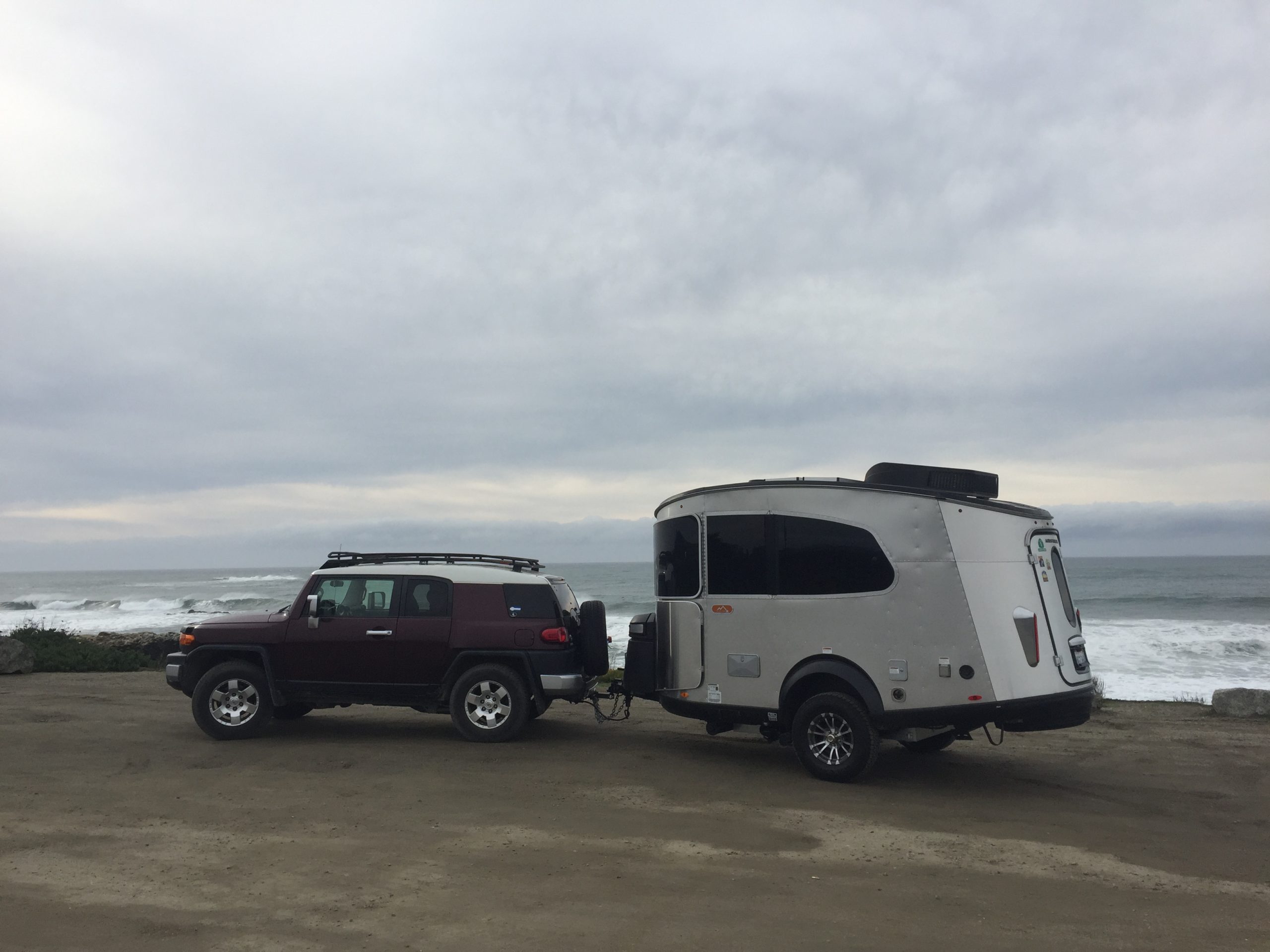 Airstream Travel Trailer RV Camper Trailer Basecamp being towed by Toyota