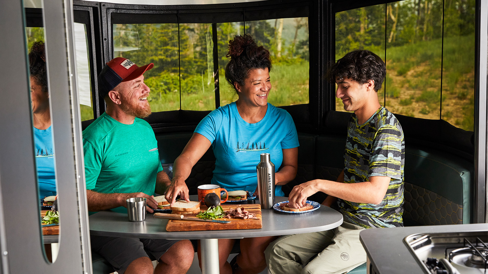 Airstream-Basecamp-20-Front-Dinette-up-in-Eating-Position-with-Family