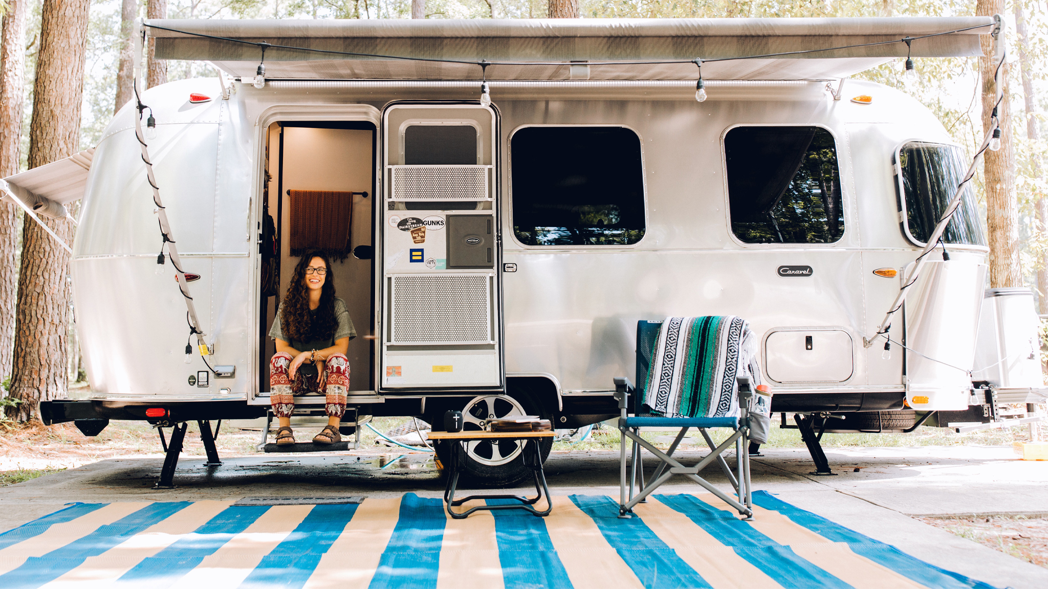 Airstream Ambassador Marisa sitting on the steps of her Airstream Travel Trailer