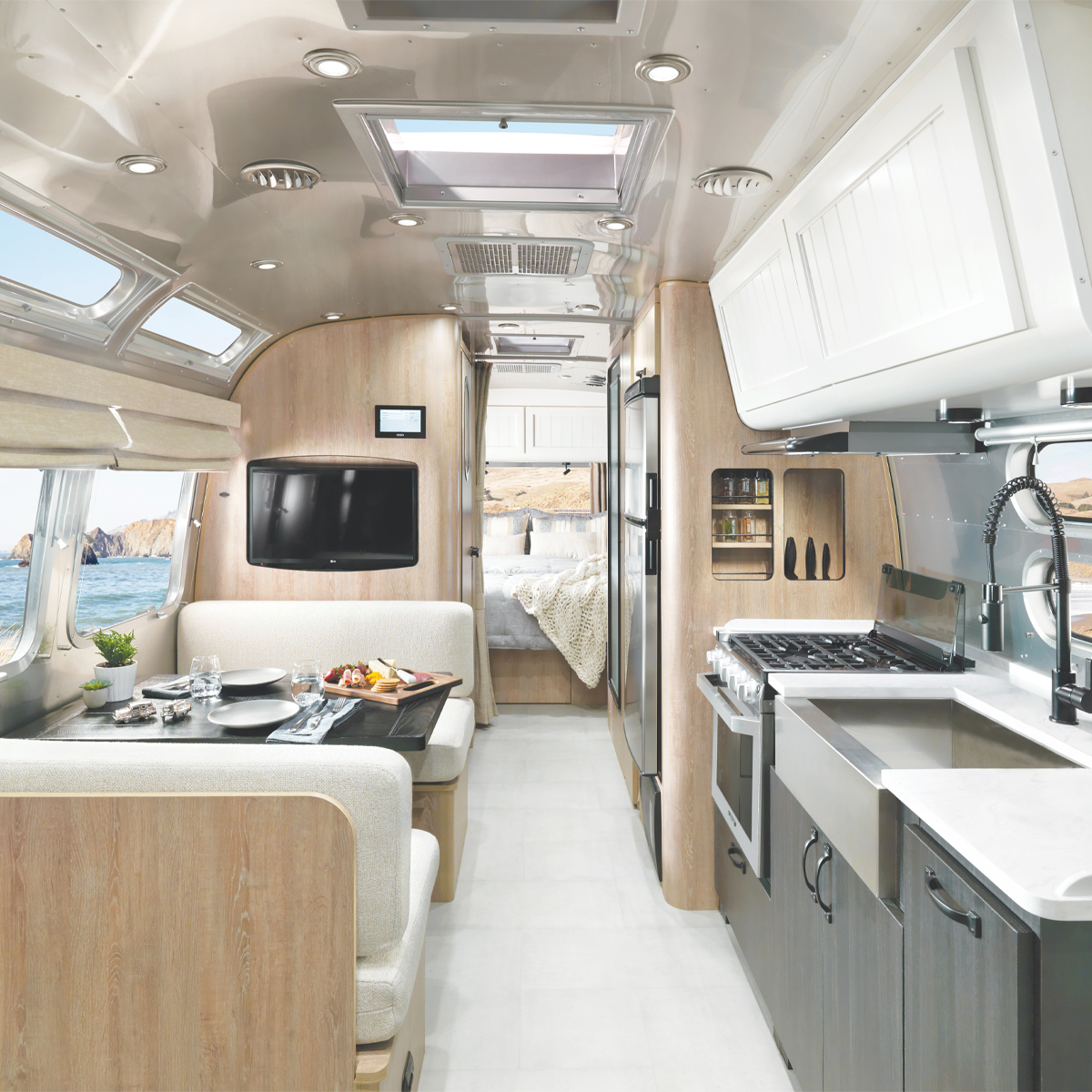 Airstream Pottery Barn Special Edition Travel Trailer interior image of dining space, kitchen, and bedroom