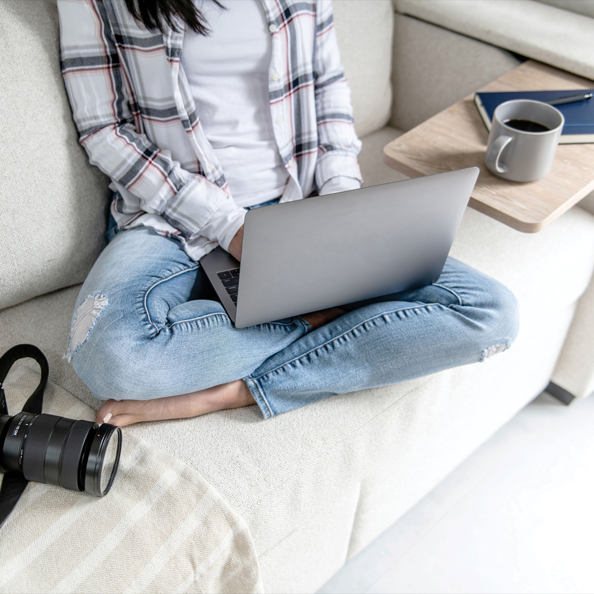 A woman working on the sofa in the Airstream Pottery Barn Special Edition Travel Trailer