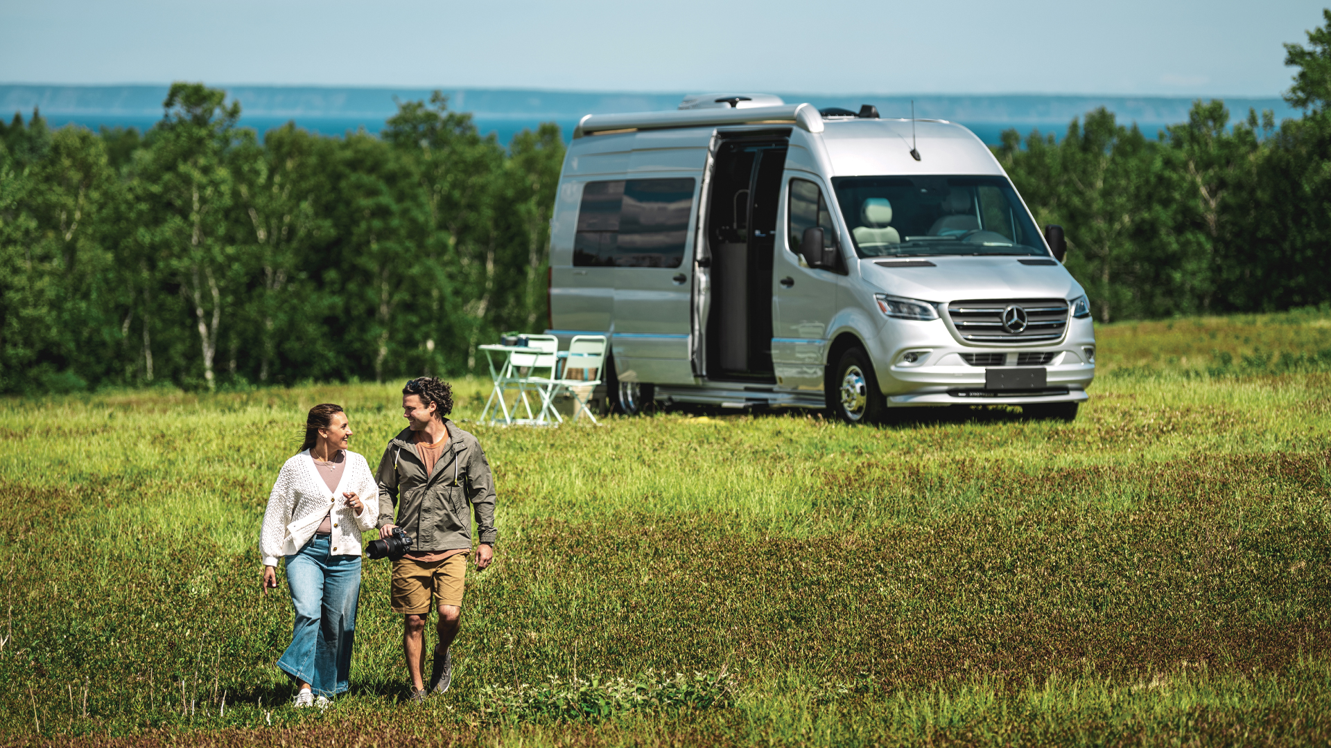 Airstream Class B RV Interstate 24 in the field with people walking