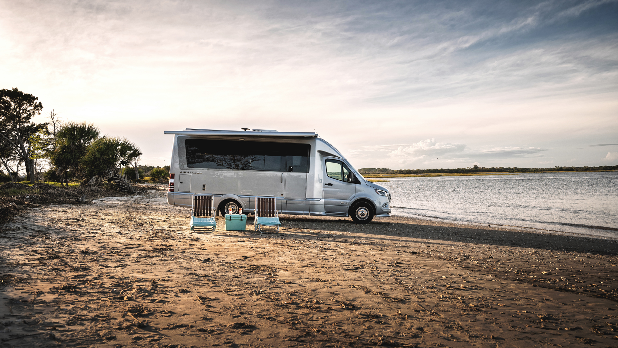 Airstream Atlas Class B Motorhome sitting on the beach