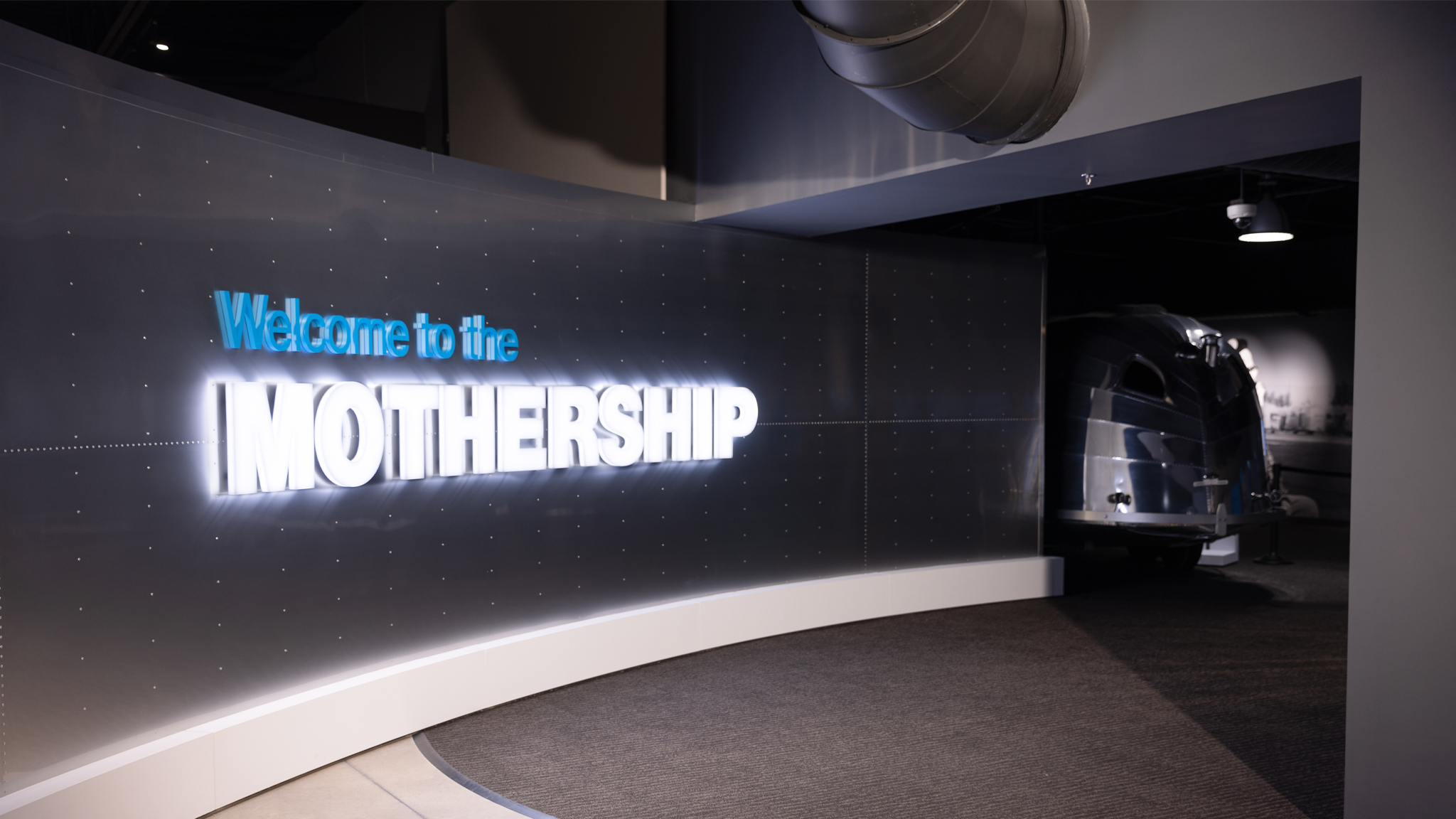 Airstream Heritage Center entrance with a sign that says Welcome to the Mothership and a vintage trailer