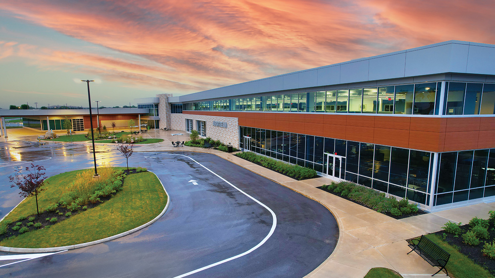 Airstream Inc. headquarters in Jackson Center, Ohio after a rainy evening with a pink and purple sunset.