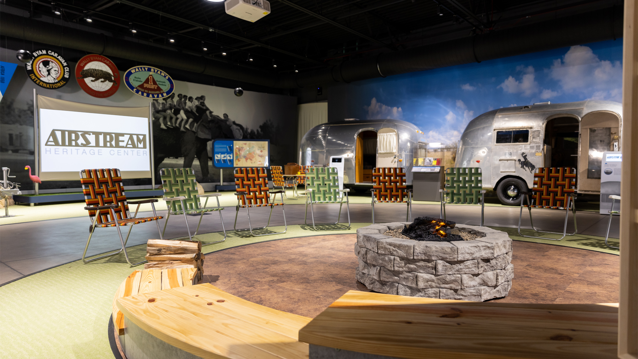 Airstream Heritage Center display of vintage travel trailers and a campfire with chairs to sit in while watching a movie
