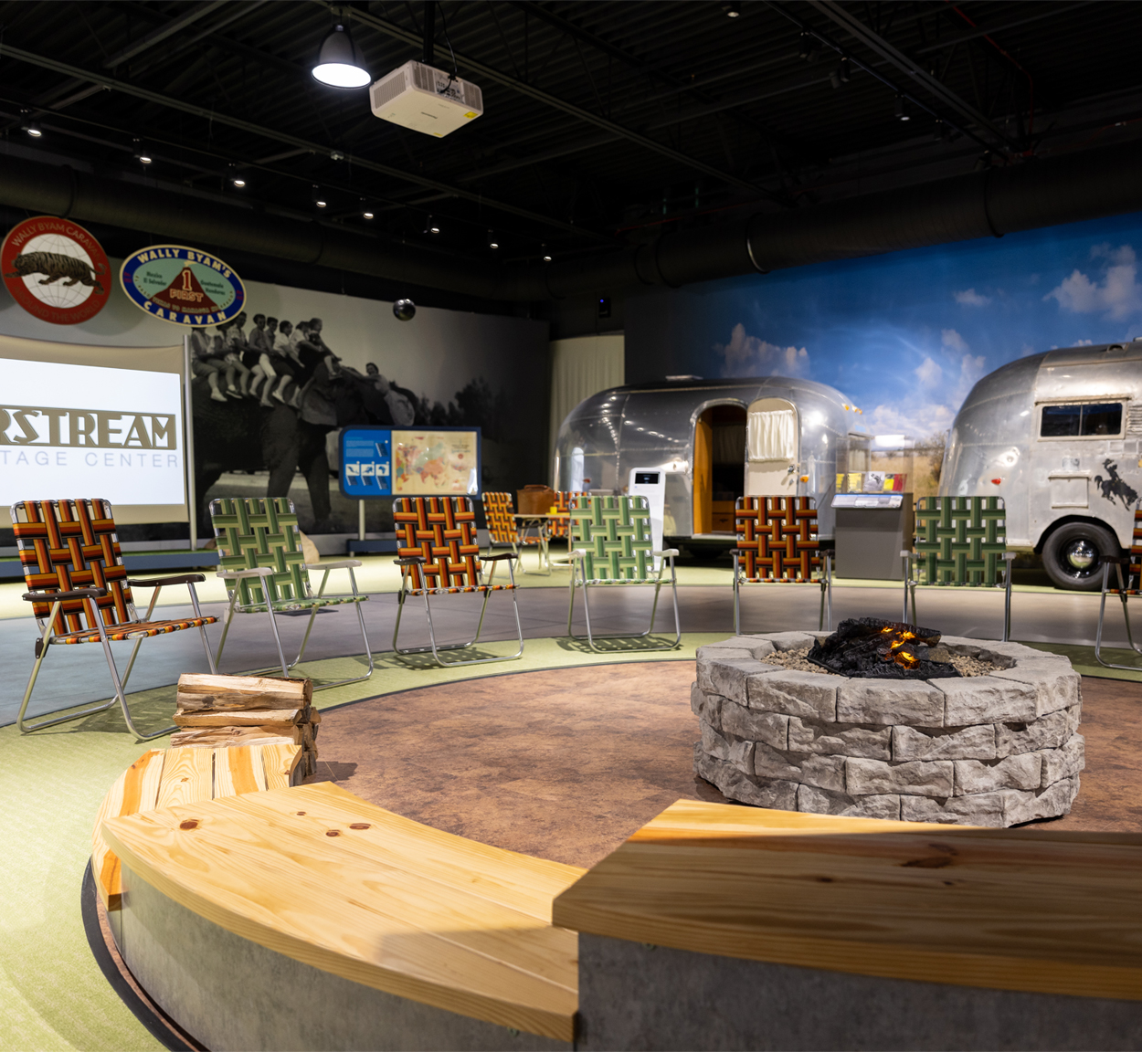 Airstream Heritage Center display of vintage travel trailers and a campfire with chairs to sit in while watching a movie