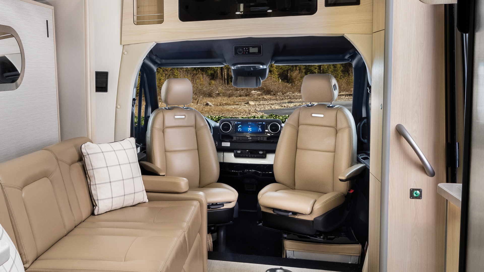 Airstream Touring Coach Class B interior showing the captains chairs
