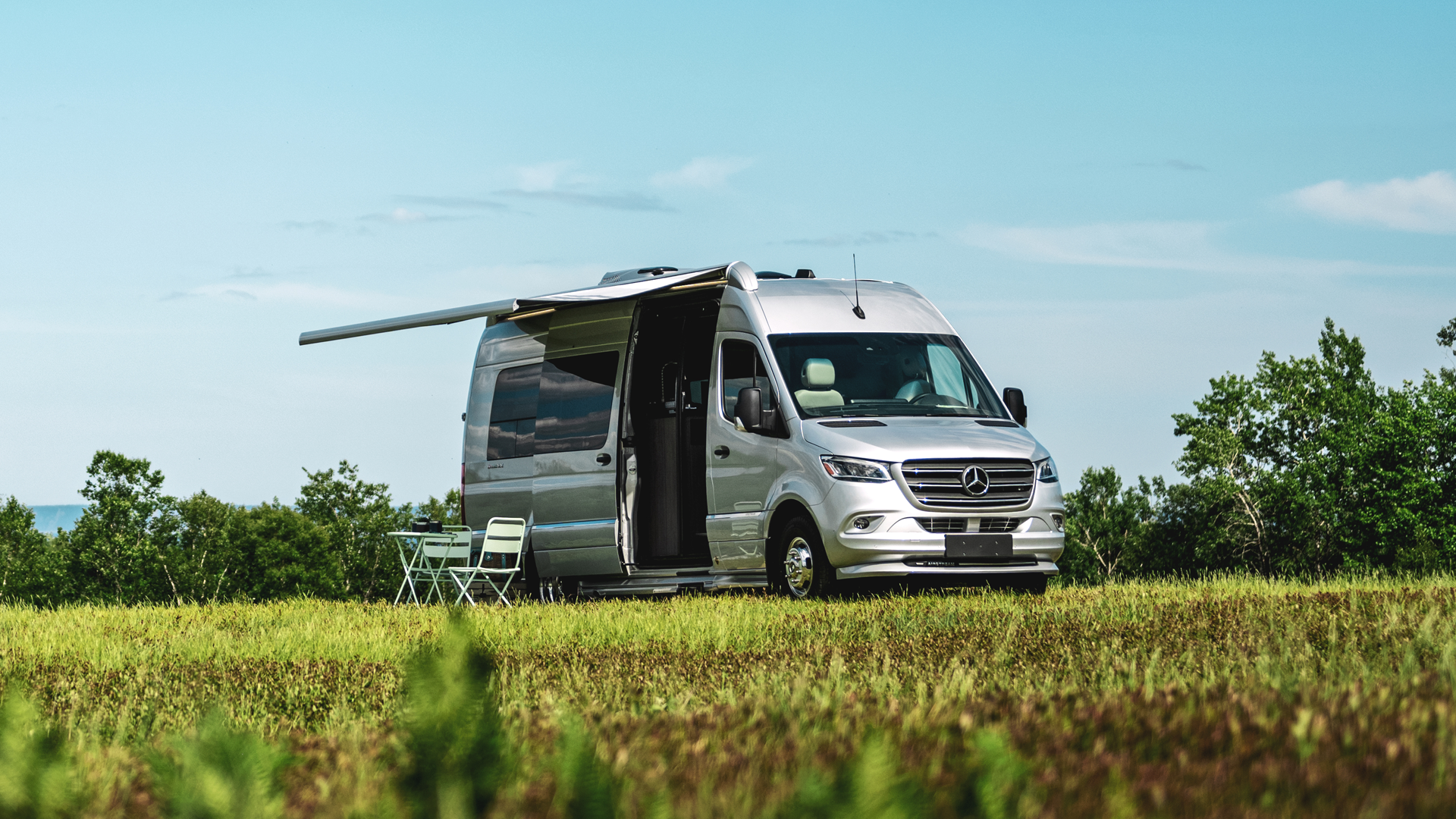 Airstream Interstate 24 Touring Coach with the awning pulled out of the class b.