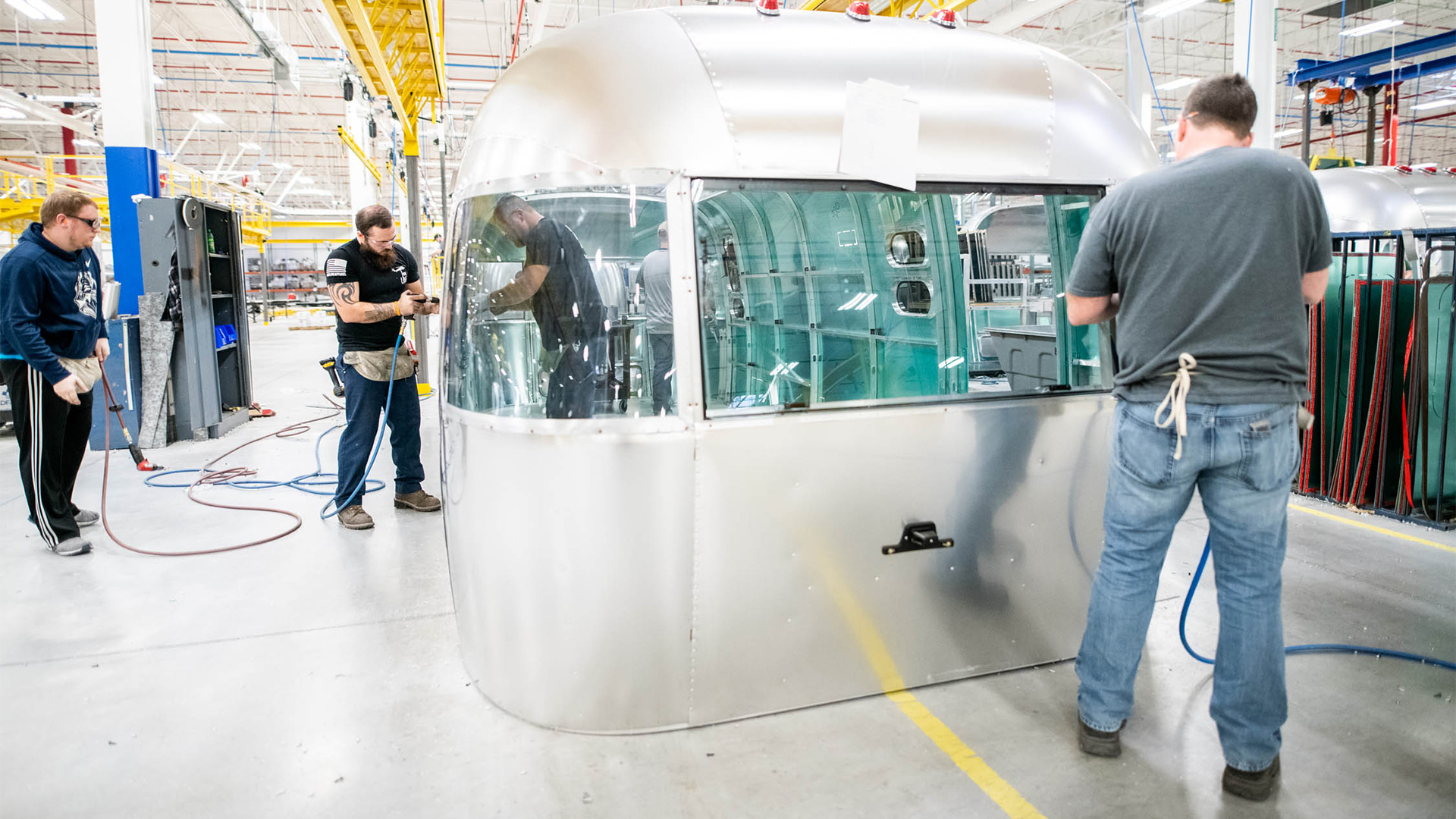 Workers at Airstream building an end cap for an Airstream travel trailer.