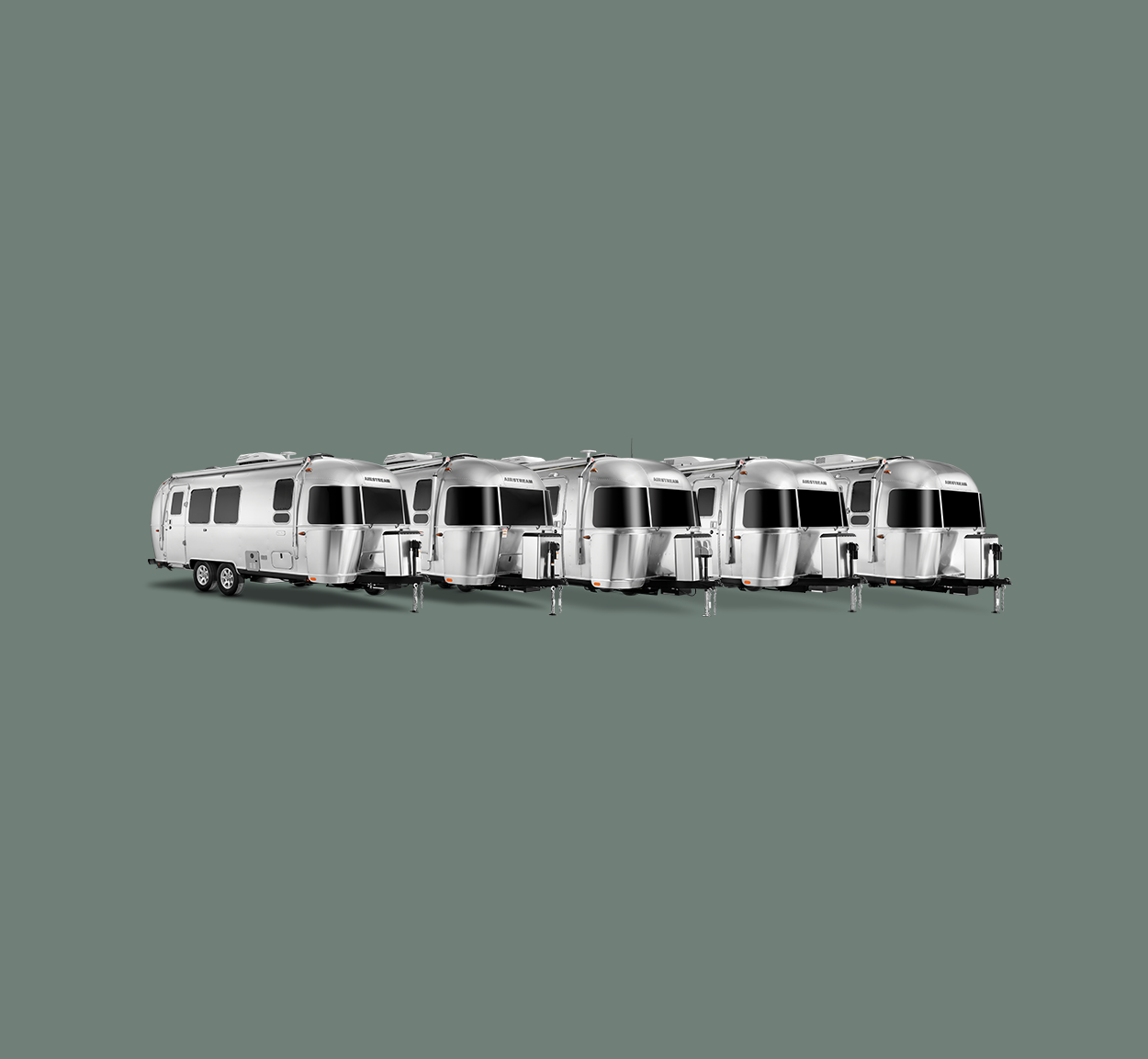 All of Airstream's dual axle travel trailers lined up in a line on a green background.
