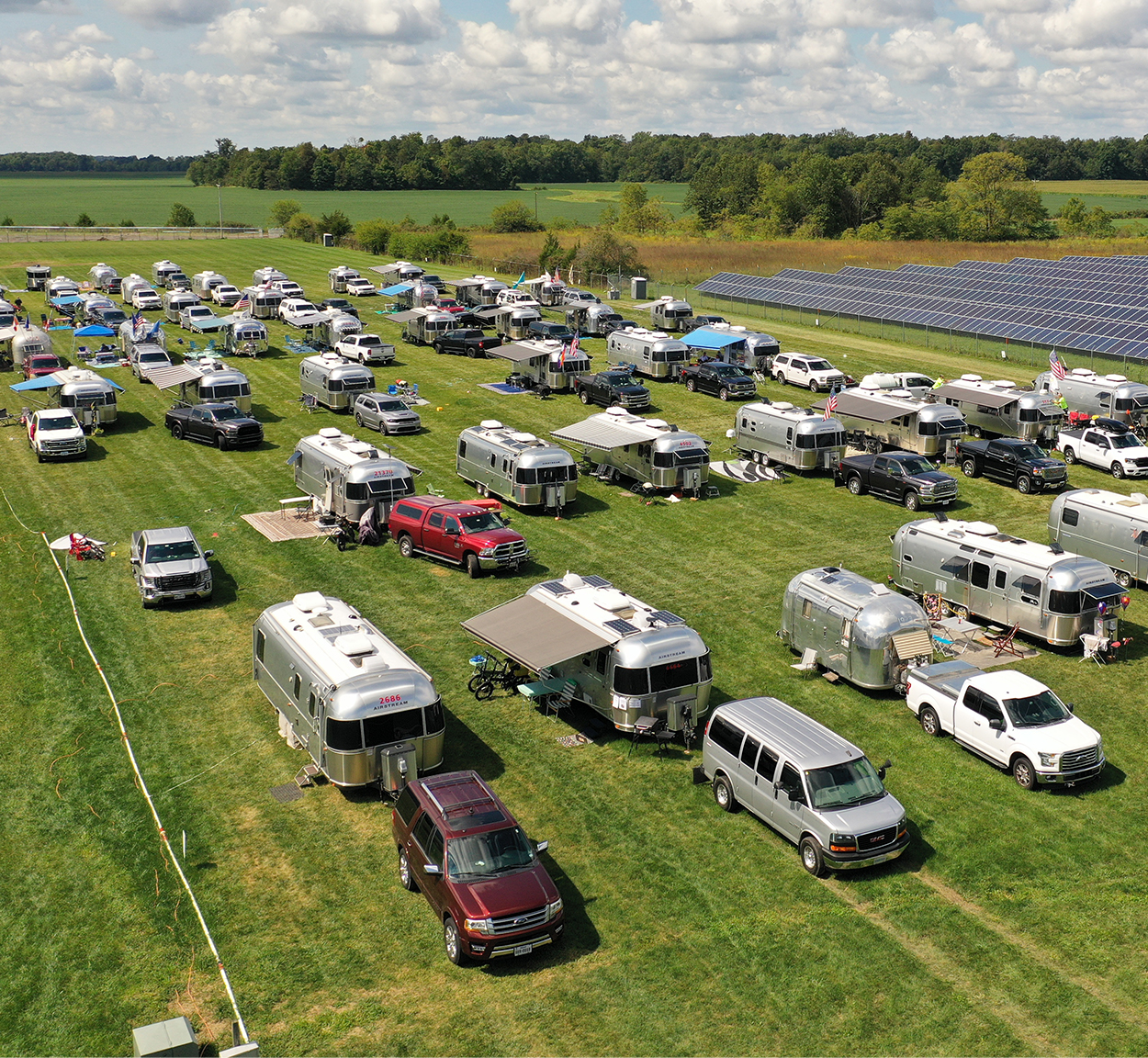 A bunch of Airstreams are camping in a field in Jackson Center for a rally.
