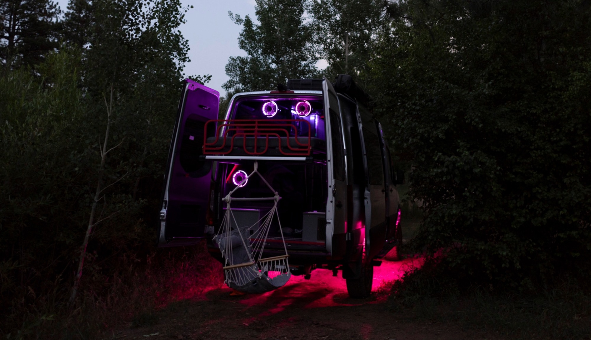 Airstream Interstate 19X Outland Edition fully extended and lit up at night.