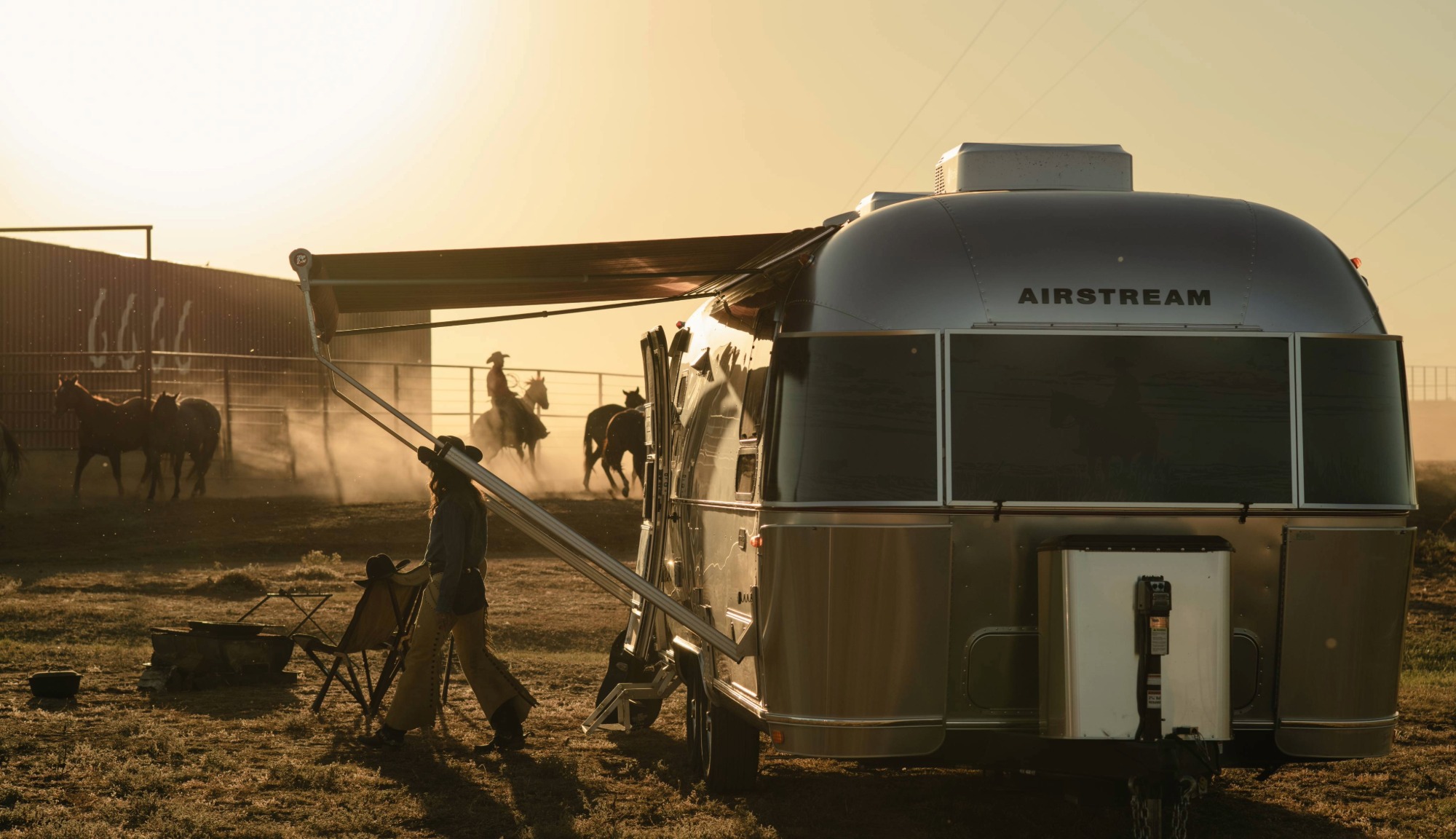 Yellowstone cowboys and cowgirls hearding on the ranch. Featuring a front view of the Airstream Stetson + 6666s Limited Edition Travel Trailer