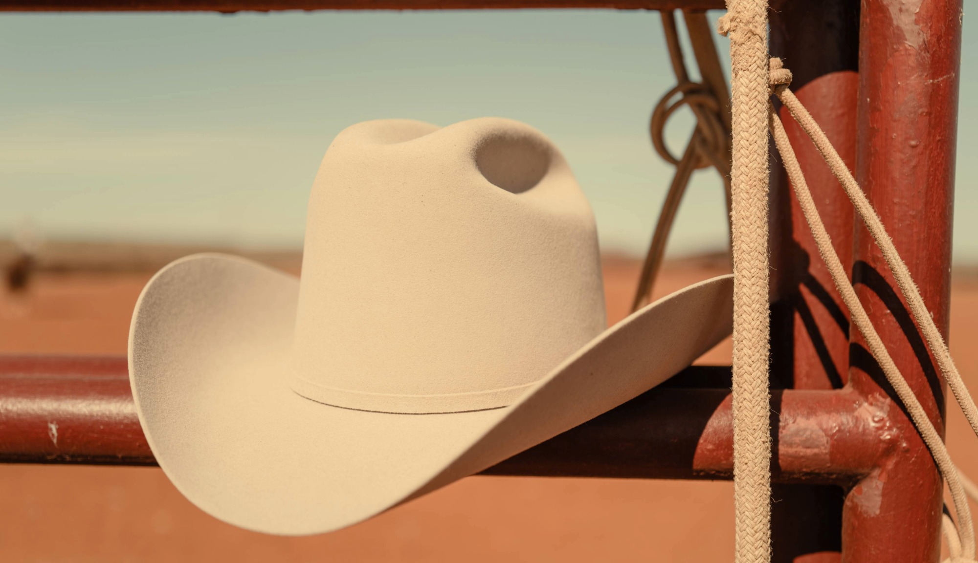 Closeup of a Stetson Hat resting on a 6666s ranch fence