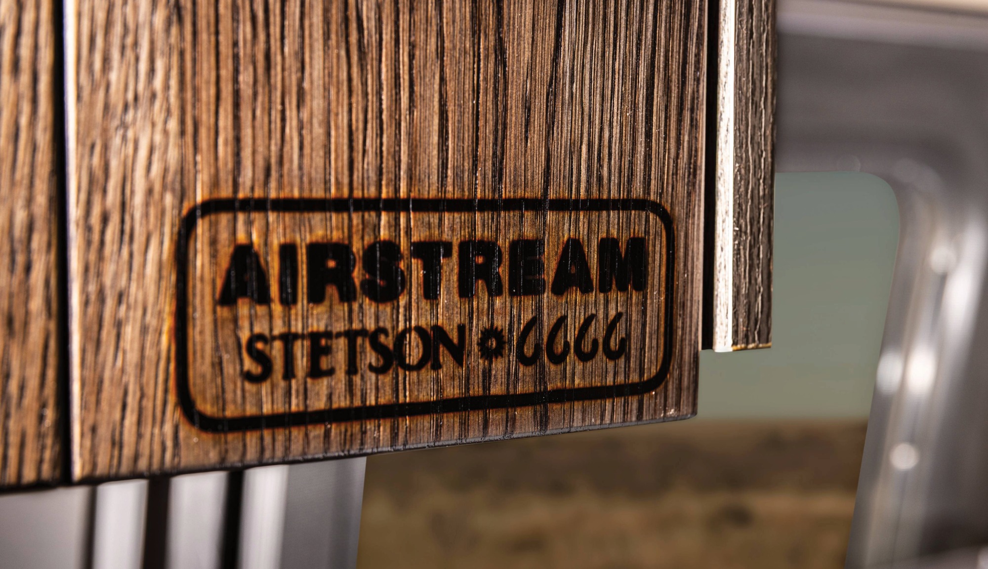 Closeup feature image of the Airstream, Stetson, and 6666s collaboration brand displayed on the Stetson + 6666s Limited Edition Travel Trailer 