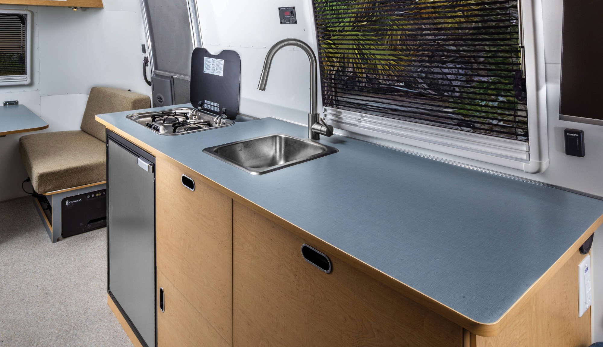 Interior of the World Traveler Travel Trailer, featuring the galley and fridge