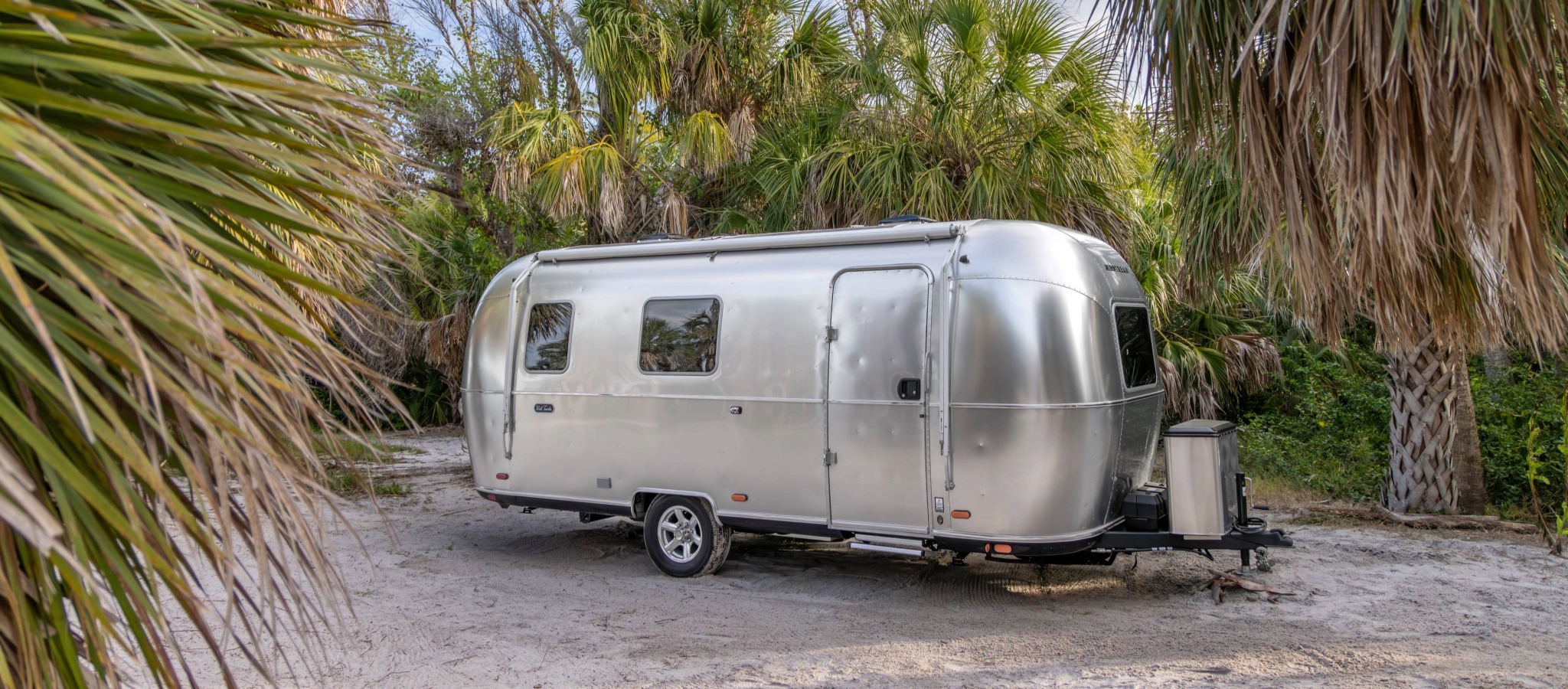 Exterior 3/4 view of Airstreams World Traveler Travel Trailer camping