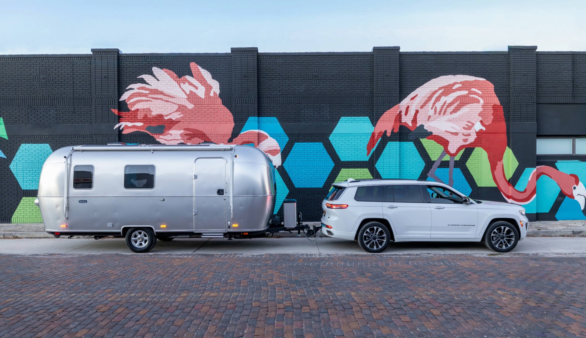 Airstream World Traveler Travel Trailer in tow behind a Jeep Grand Cherokee suv