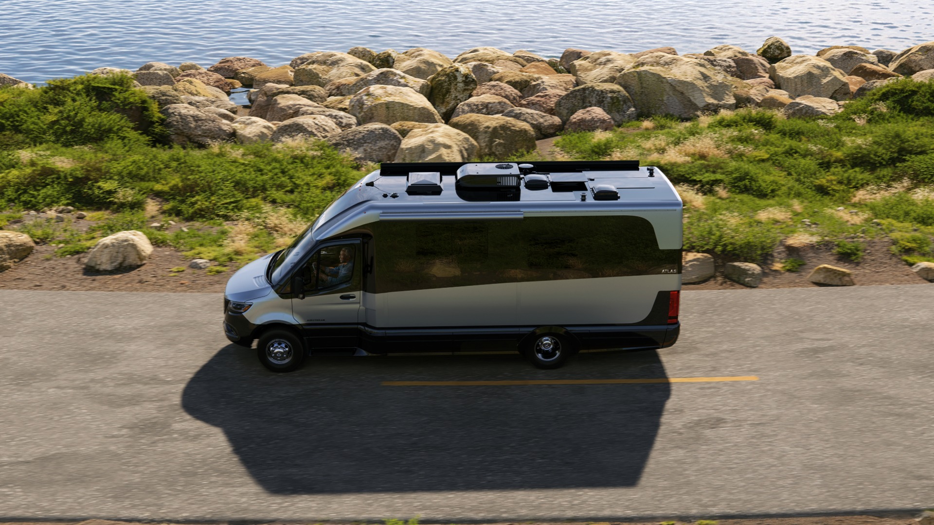 Atlas 25MS Camper van in Hightech Silver Ultra Premium Paint birdeye view driving down a costal road
