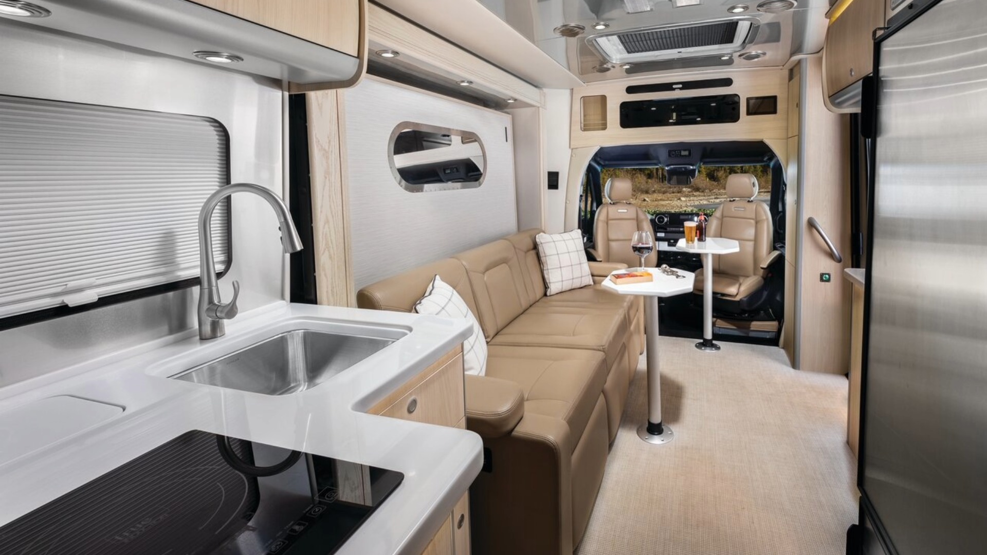 Airstream Atlas 25MS Classic Canyon Galley and sofa with attachable table and snacks