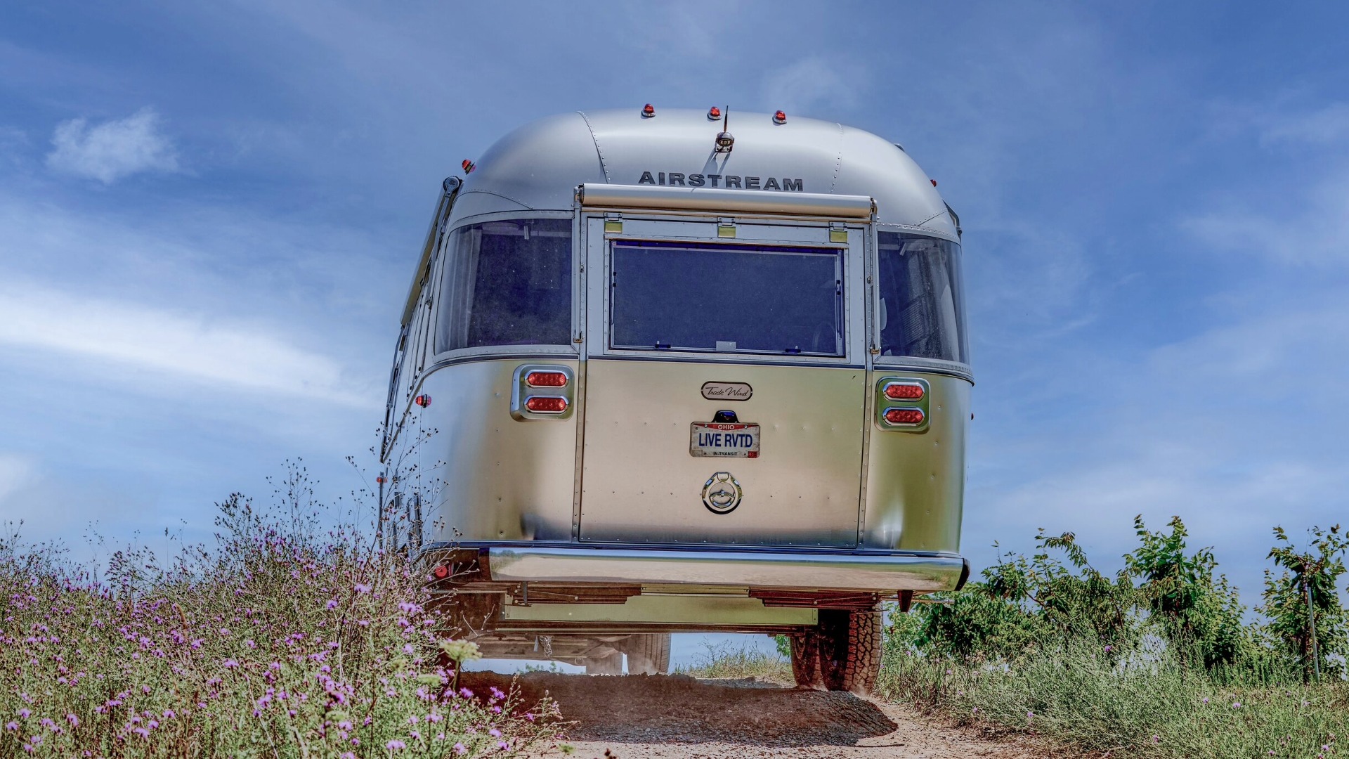 Trade Wind Travel Trailer driving up a high clearence dirt path