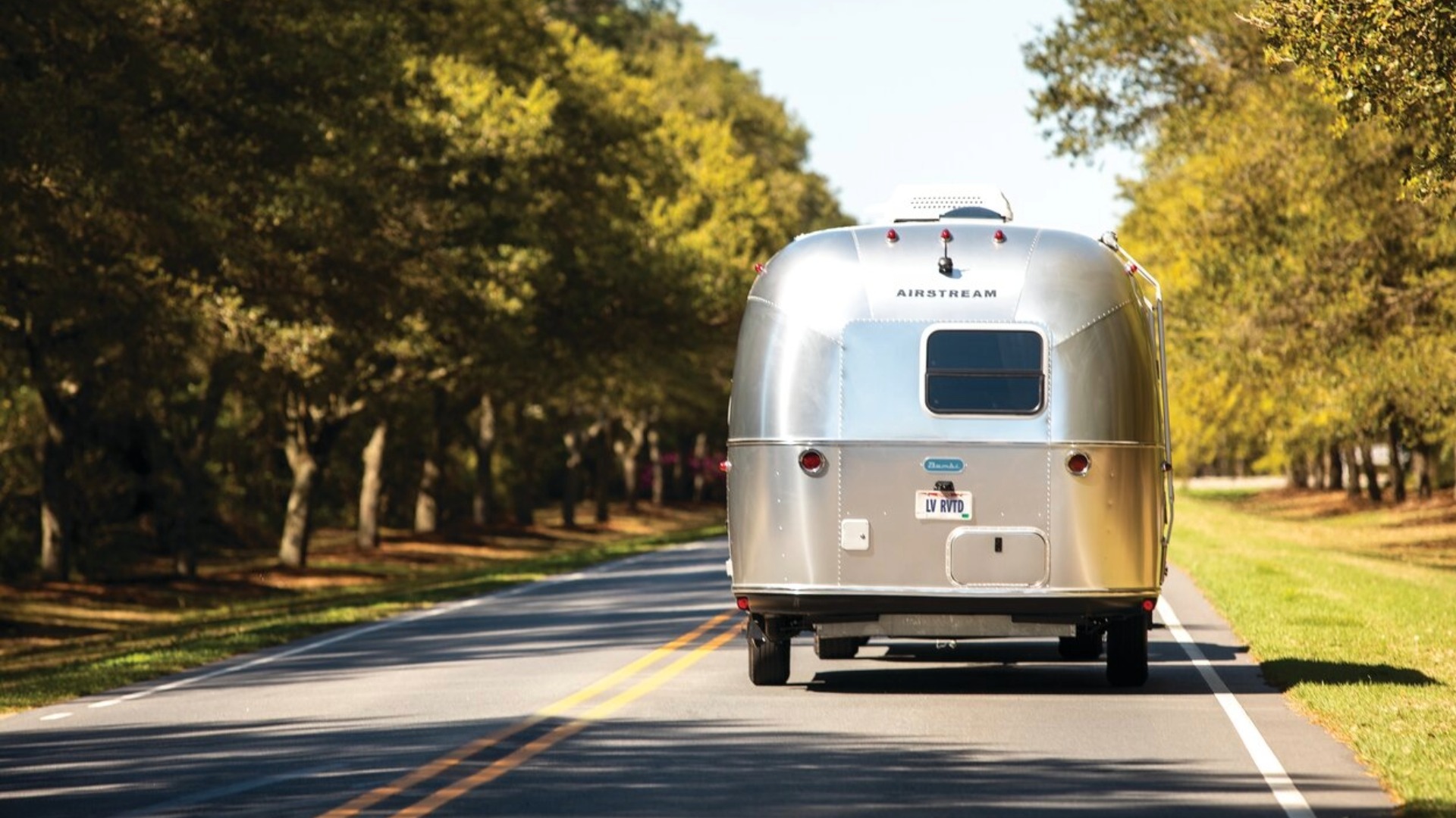 Airstream Bambi RV being towed with an SUV
