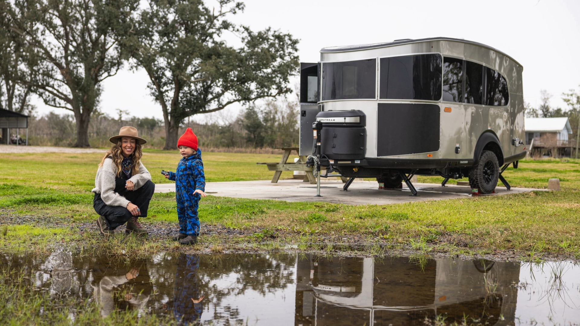 Shy on the Fly and son in front of parked Basecamp XE 