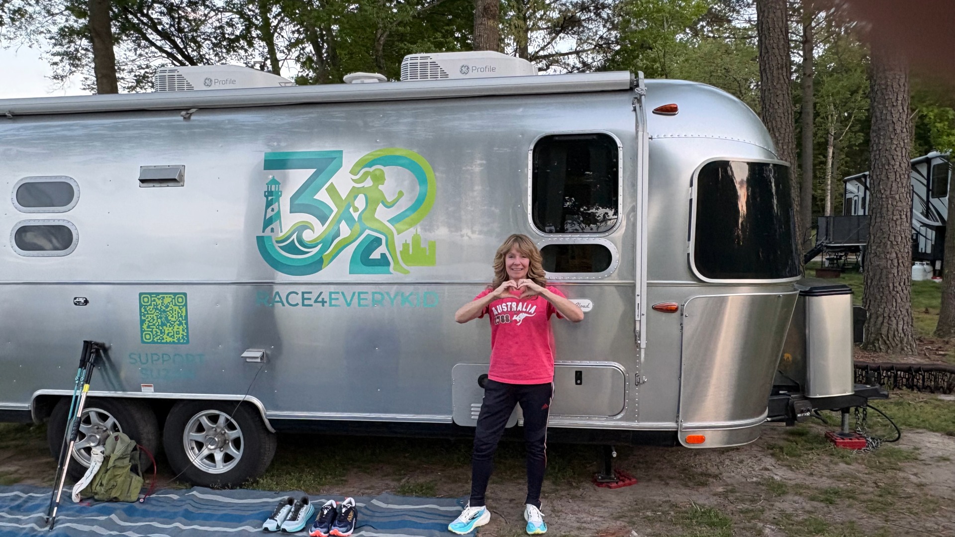 Lady standing outside an Airstream trade wind with running gear